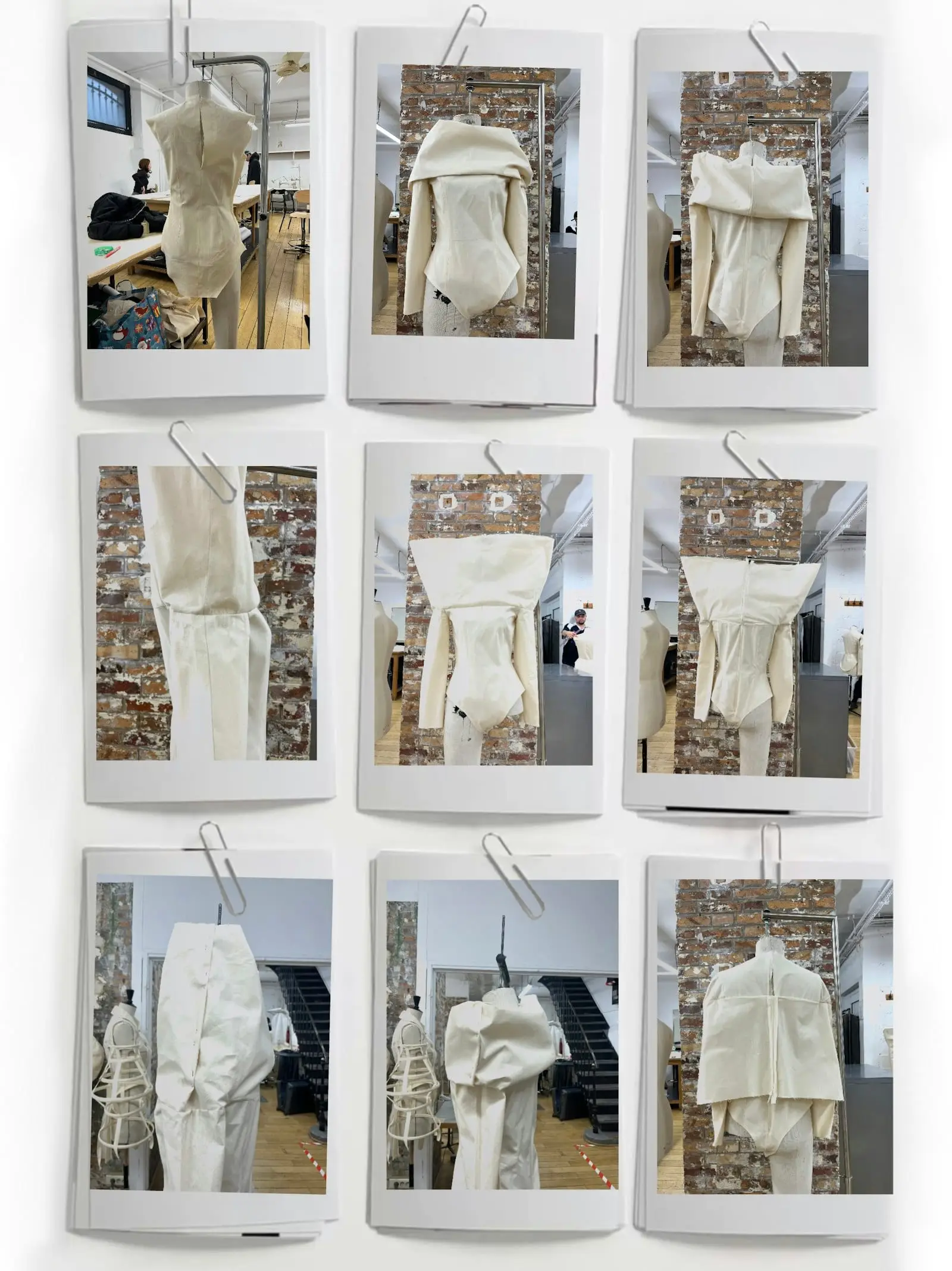 White garments pinned to boards in a fashion studio