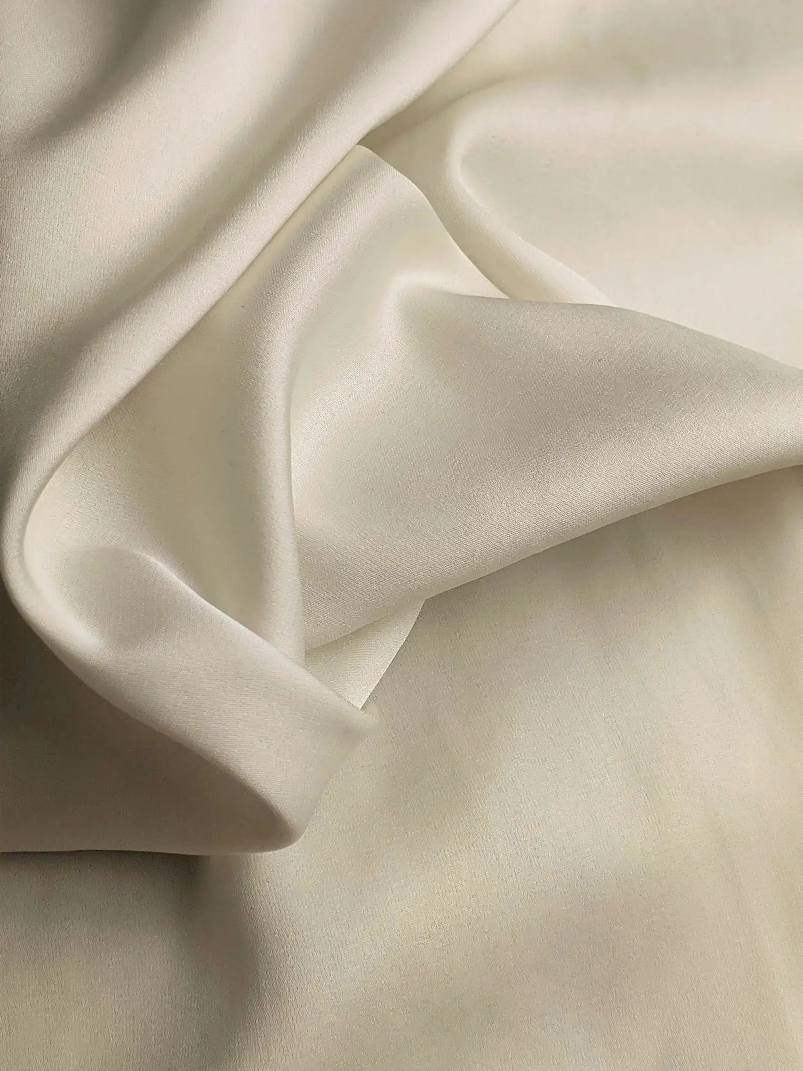 Draped ivory silk fabric in soft folds
