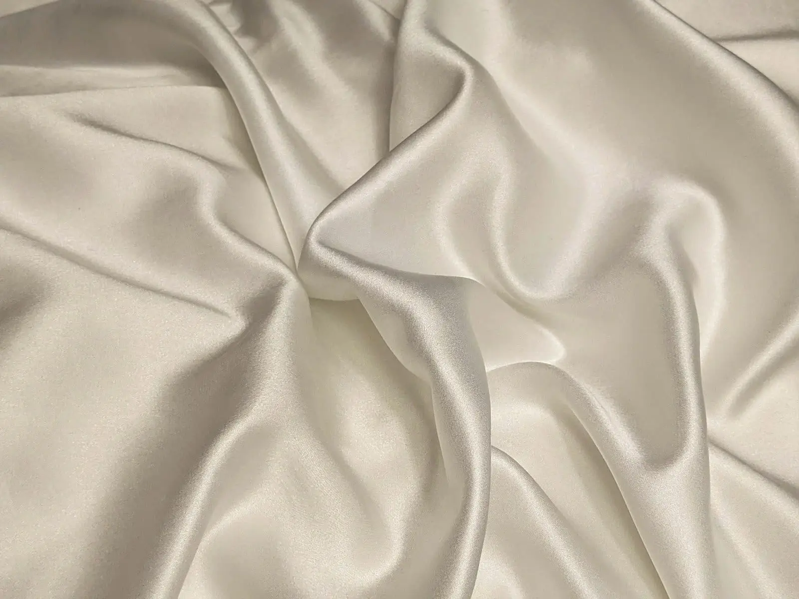 Soft folds of ivory silk fabric